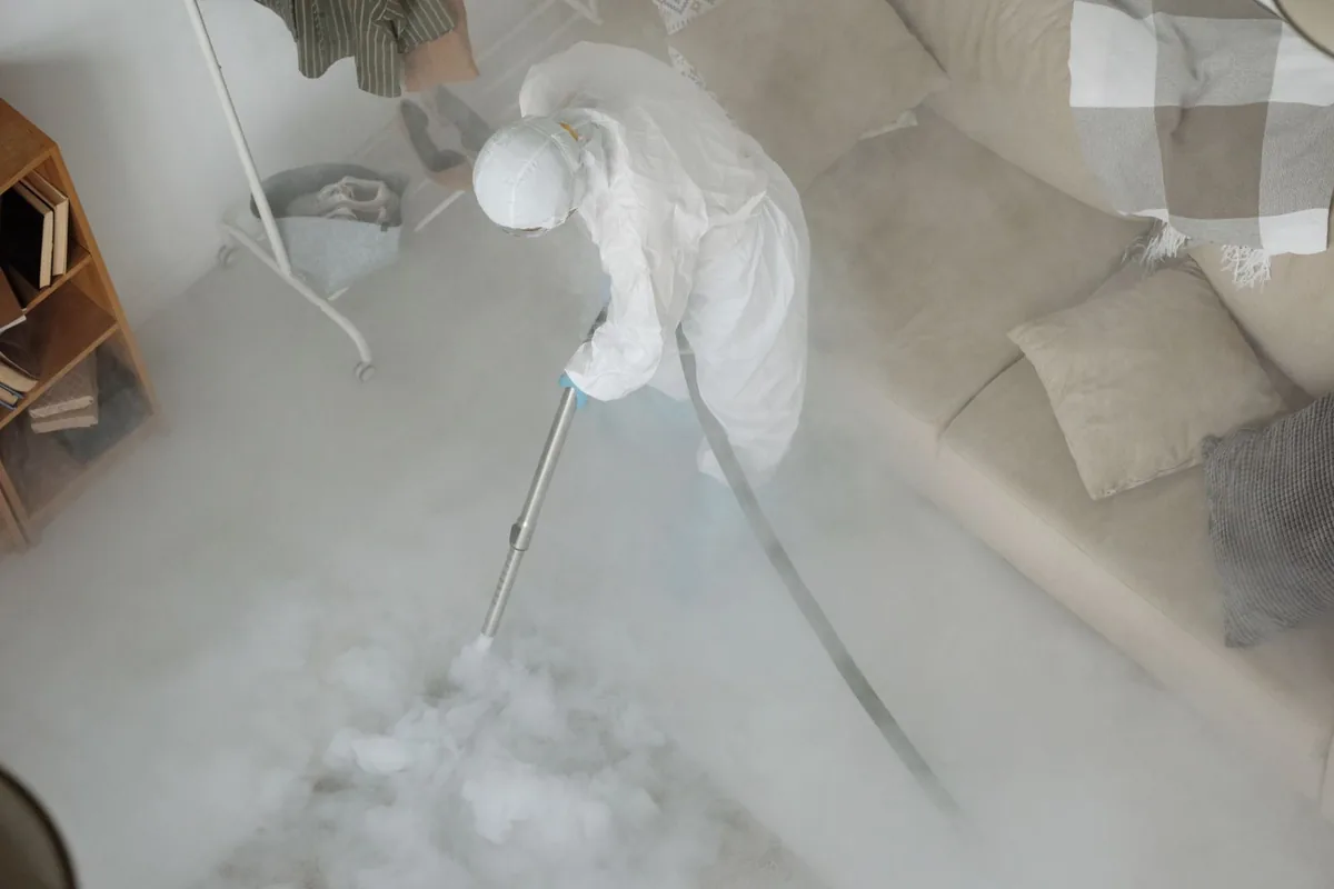 Biohazard cleanup technician in protective equipment, Rockridge, Oakland, CA